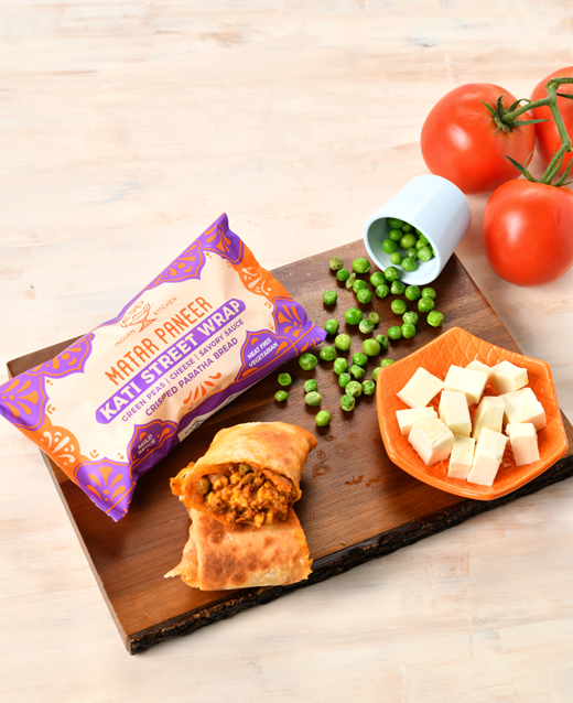 Matar Paneer Kati Street Wrap with ingredients surrounding